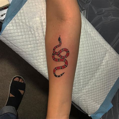 gucci snake tattoo on face